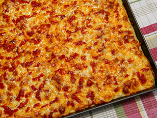 Medium-thin, crispy crust topped with sauce, cheese, and more sauce